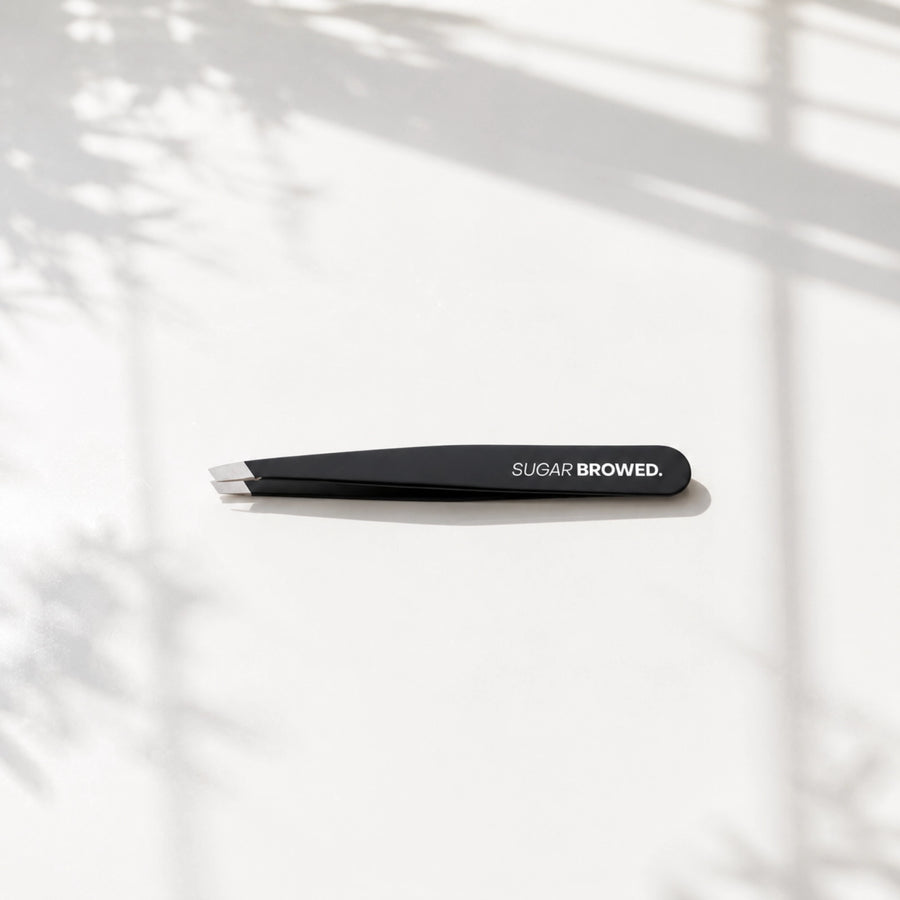 Professional black slant-tip tweezers for precise eyebrow shaping and hair removal – sleek, matte finish