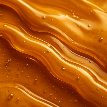 High-resolution close-up of golden honey with smooth, rich texture – inspiration for Sugar Browed brow extensions.