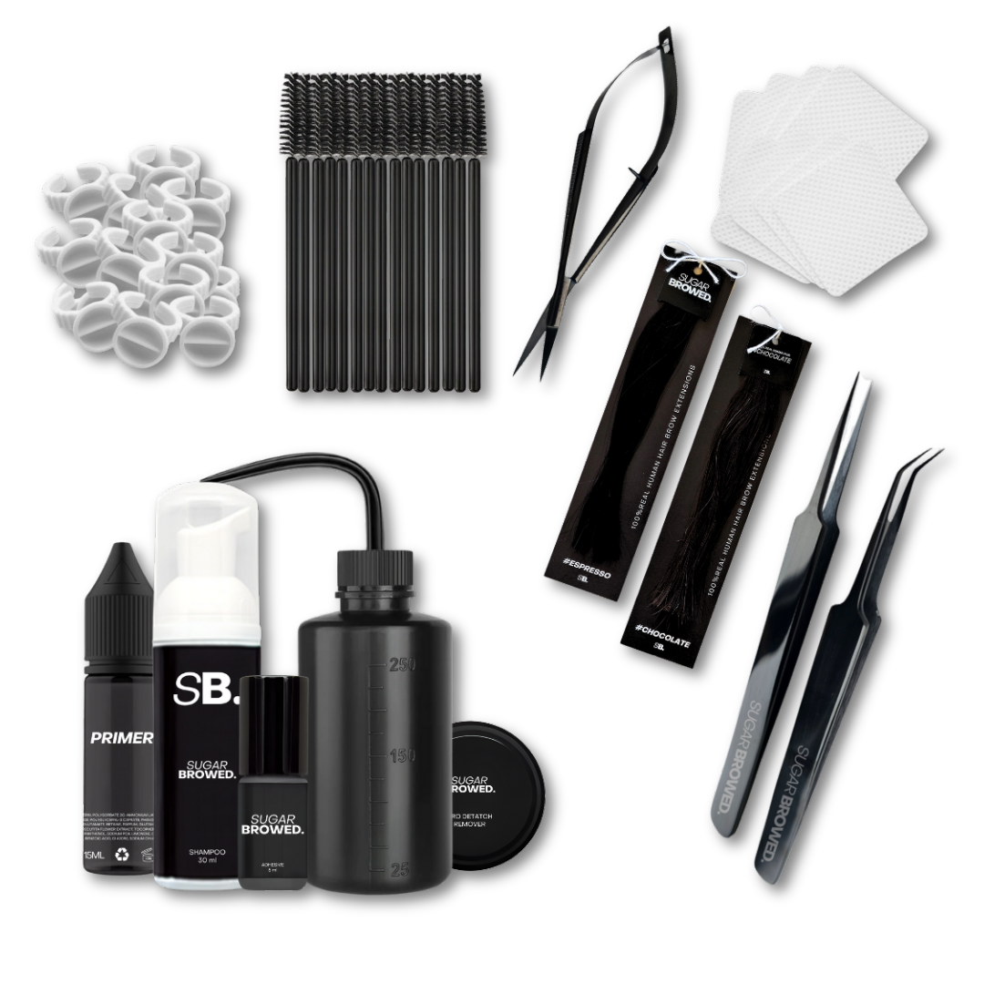 Complete brow extension starter kit beautifully arranged in a branded box, featuring professional tools including isolation and placement tweezers, water bottle, adhesive, brushes, cleansing brush, brow shampoo, brow extensions in two shades, wipes, and glue rings, ideal for beginner and advanced stylists.