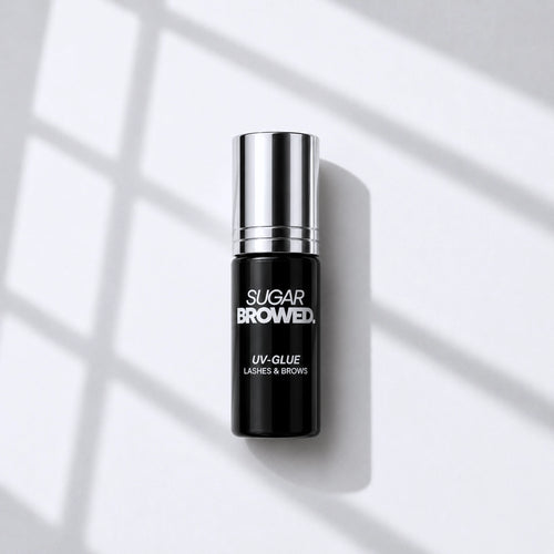 High-resolution product image of SUGAR BROWED UV Glue for brow extensions, professional adhesive bottle with silver cap, showcased on a clean background.