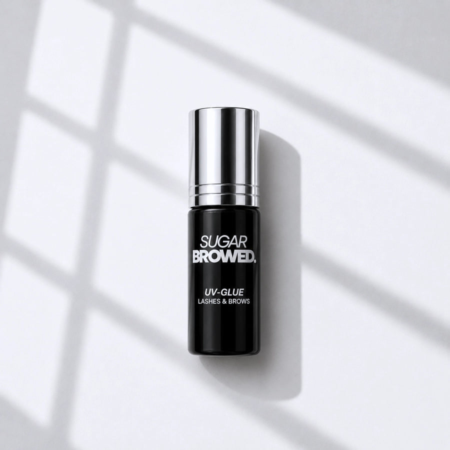 High-resolution product image of SUGAR BROWED UV Glue for brow extensions, professional adhesive bottle with silver cap, showcased on a clean background.
